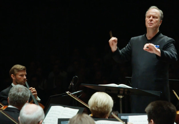 Man smiling at the orchestra. from the concert.